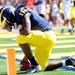 Michigan junior quarterback Denard Robinson stops at the edge of the end zone for a moment after running the ball to score a touchdown during the second quarter against Eastern Michigan at Michigan Stadium on Saturday. Melanie Maxwell I AnnArbor.com